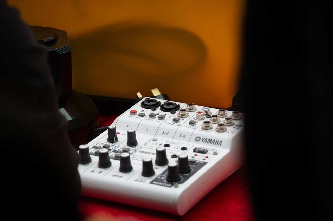 Mastering the First Impression: Your intriguing post title goes here Detailed view of a Yamaha audio mixer with knobs and inputs in a studio setting.