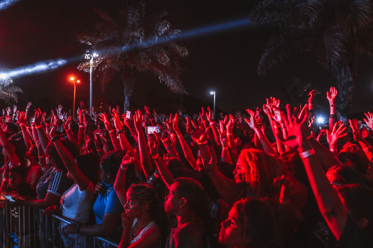 The Art of Drawing Readers In: Your attractive post title goes here A lively crowd enjoying a night outdoor music festival under bright stage lights.